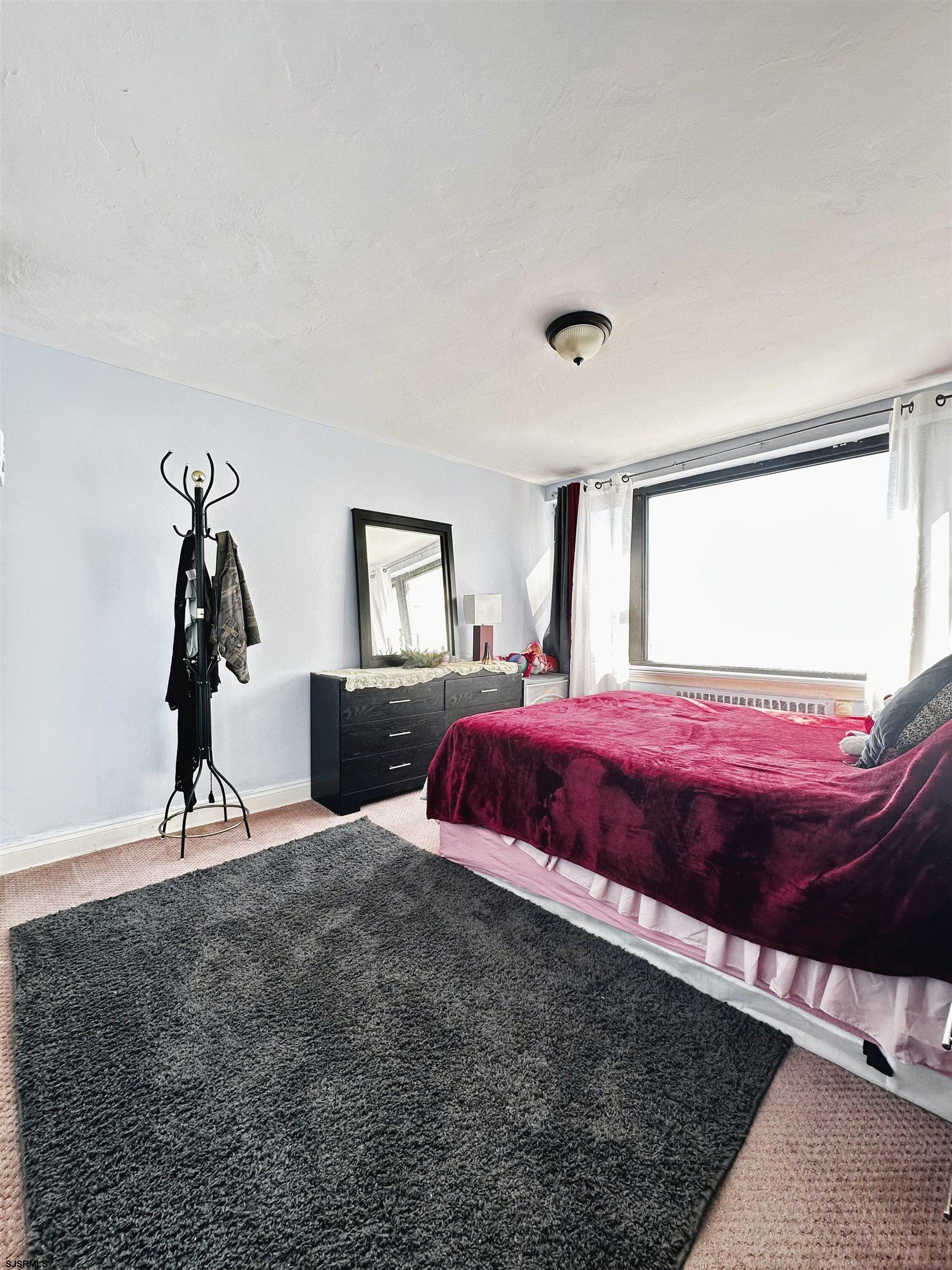 101 South Raleigh Avenue, Unit 232 Atlantic City, NJ 08401 - Photo 9 of 18 a bedroom with a bed and a potted plant on the dresser