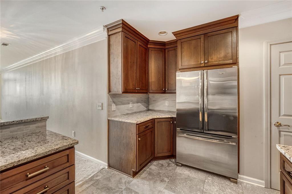 3334 Peachtree Road Northeast, Unit 1208 Atlanta, GA 30326 - Photo 8 of 23 a kitchen with a refrigerator stove and cabinets