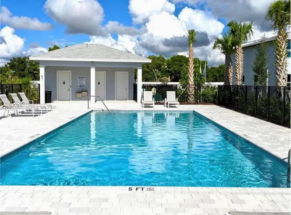 a view of a house with a swimming pool and a yard