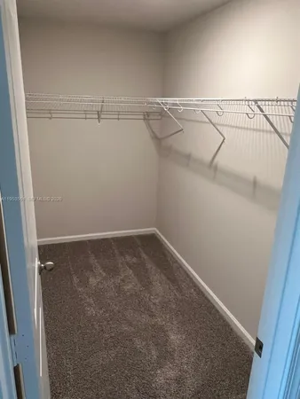a white toilet and tub sitting next to a bathroom sink