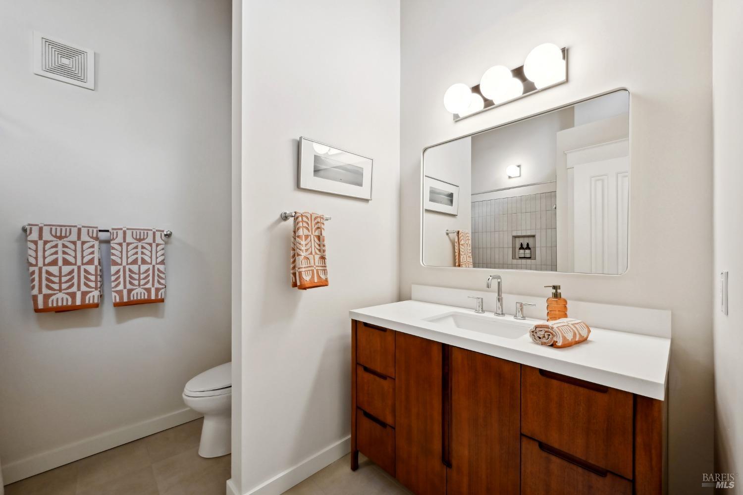 16495 Burl Lane Occidental, CA 95465 - Photo 20 of 31 a bathroom with a sink vanity granite toilet and a mirror
