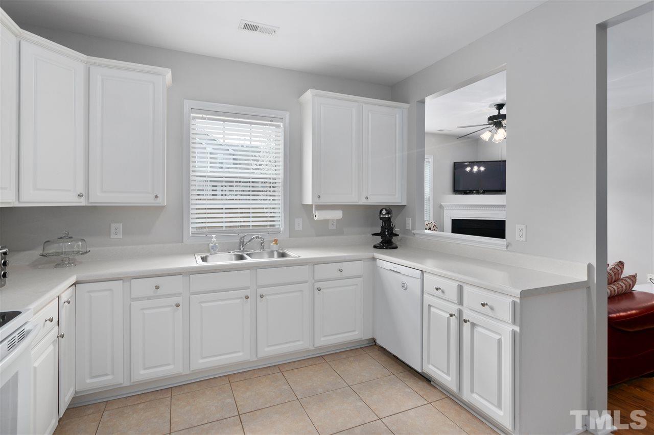 2744 Andover Glen Road Raleigh, NC 27604 - Photo 12 of 29 a kitchen with white cabinets and sink