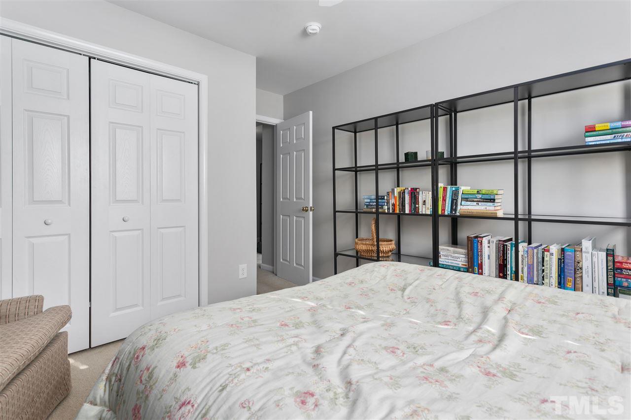 2744 Andover Glen Road Raleigh, NC 27604 - Photo 20 of 29 a bed sitting in a bedroom next to a book shelf