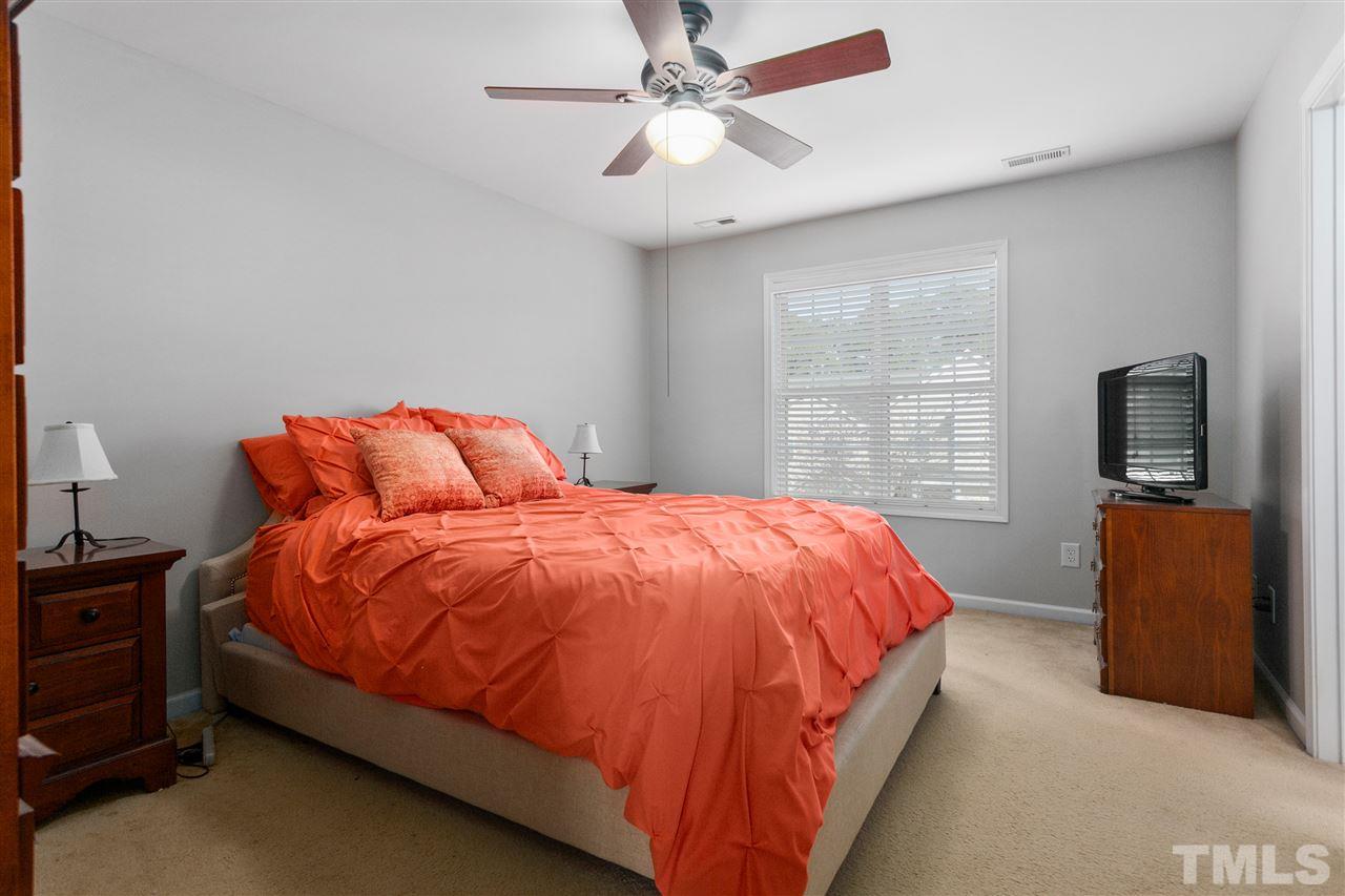 2744 Andover Glen Road Raleigh, NC 27604 - Photo 21 of 29 a bed sitting in a bedroom next to a window