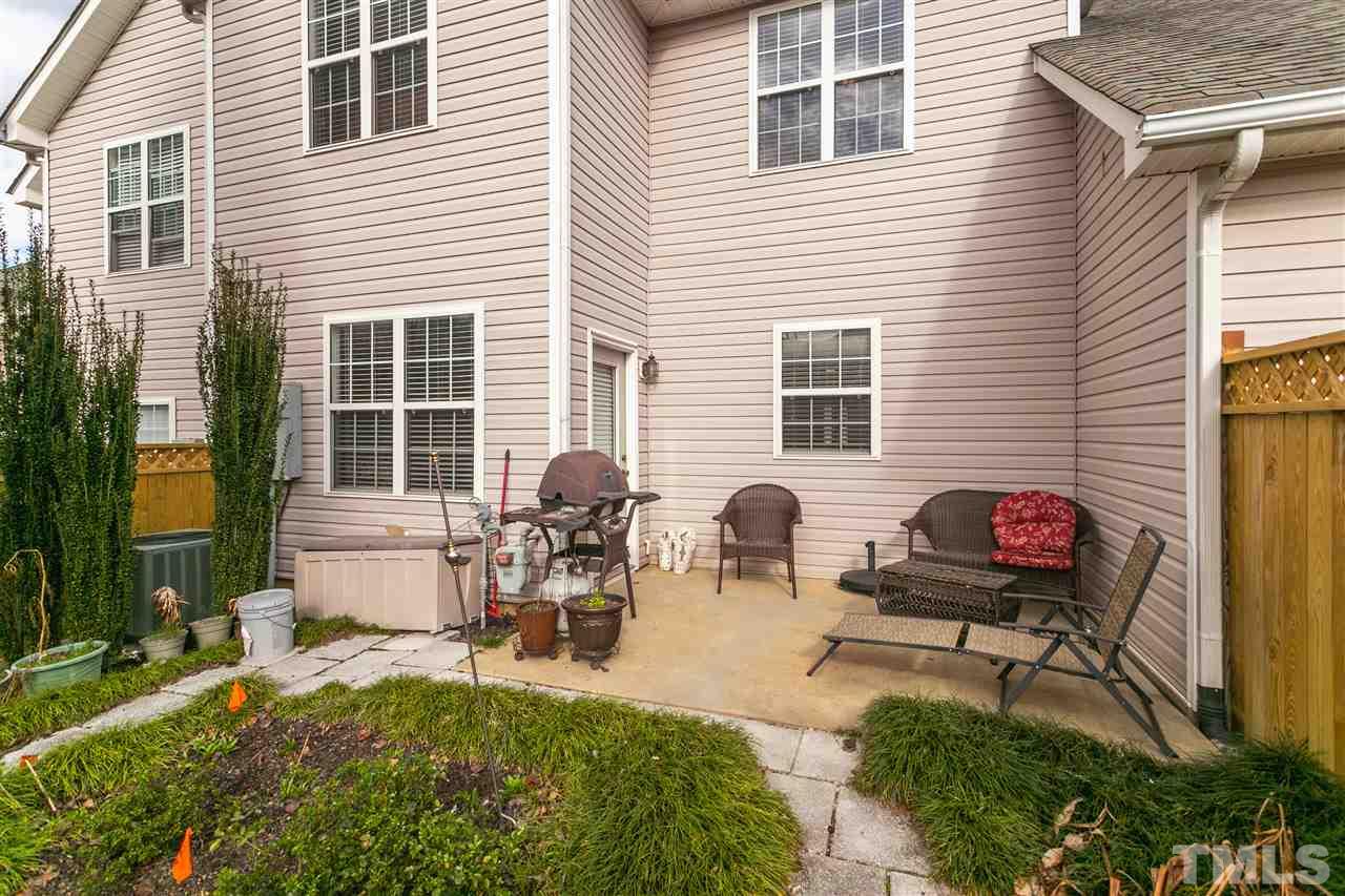 2744 Andover Glen Road Raleigh, NC 27604 - Photo 26 of 29 a view of a backyard with table and chairs and potted plants