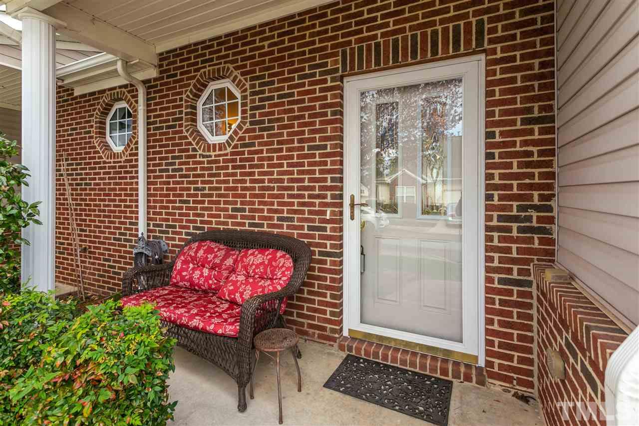 2744 Andover Glen Road Raleigh, NC 27604 - Photo 5 of 29 a brick building with a bench in front of it
