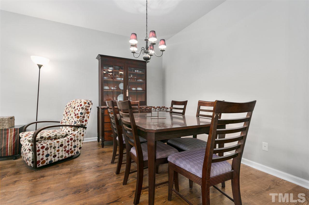 2744 Andover Glen Road Raleigh, NC 27604 - Photo 6 of 29 a view of a dining room with furniture and wooden floor