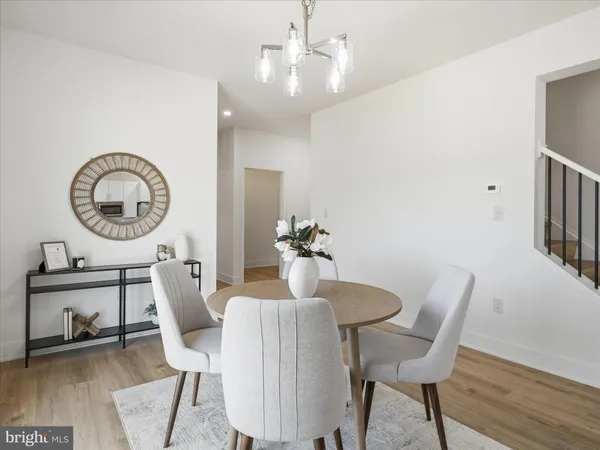 a view of a dining room with furniture and a mirror
