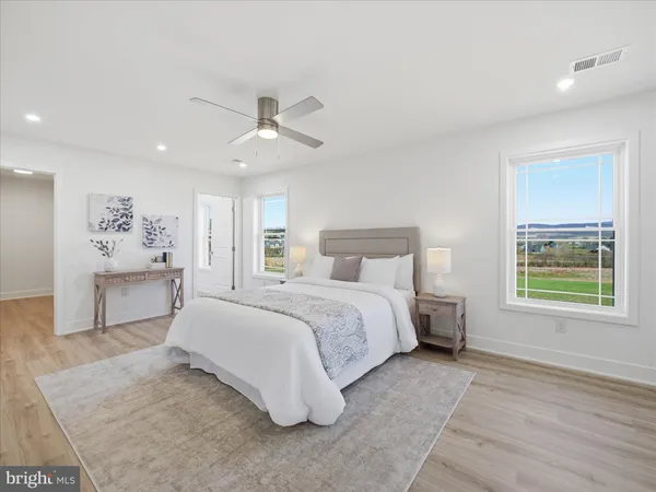 a spacious bedroom with a large bed and a window
