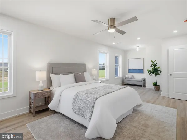 a spacious bedroom with a large bed chandelier and a window