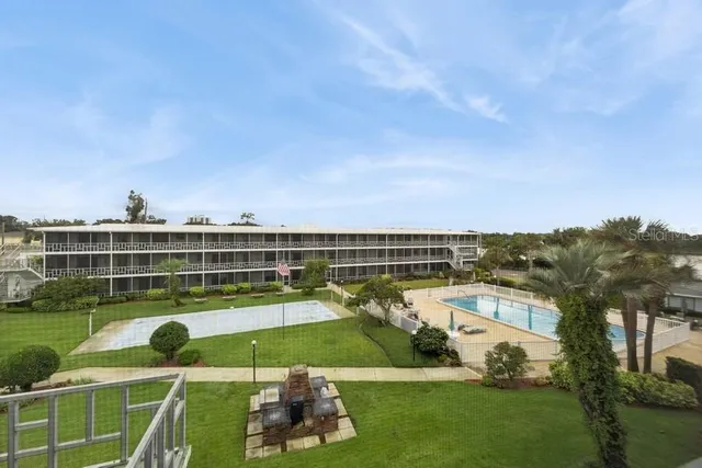 a view of a swimming pool and a yard