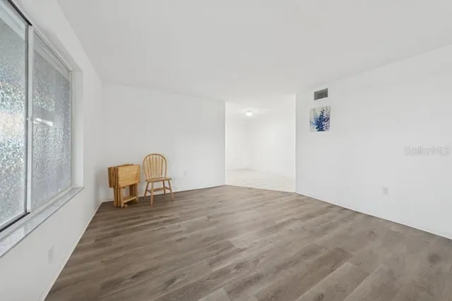 a view of a livingroom with wooden floor and chair