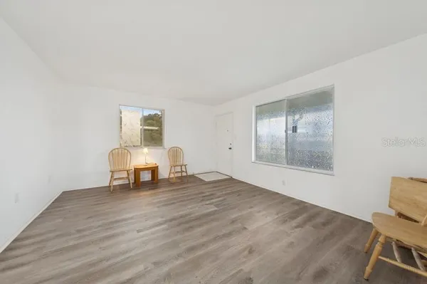 a view of work space with wooden floor and white walls
