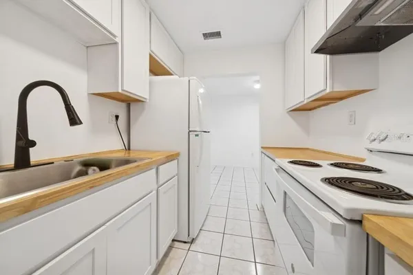 a kitchen with a sink and a stove top oven