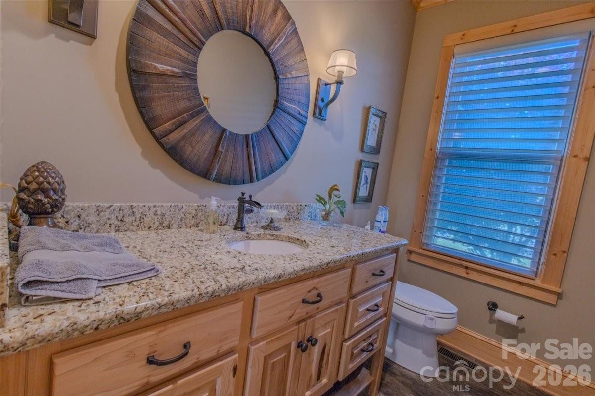 1083 Union Community Road Thurmond, NC 28683 - Photo 24 of 47 a bathroom with a granite countertop toilet sink and mirror