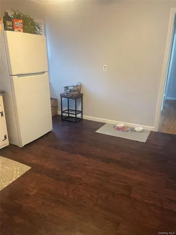 a view of livingroom with furniture and a refrigerator