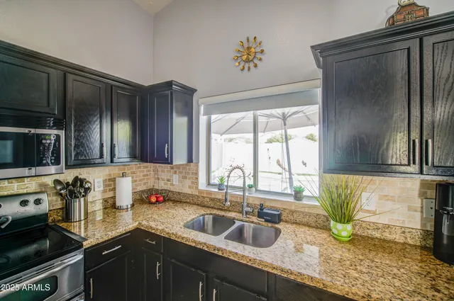 a kitchen with a sink a counter and cabinets