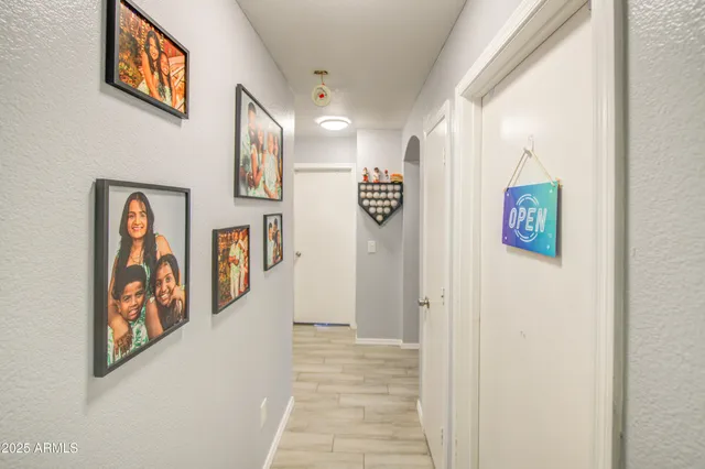 a view of a hallway with paintings on the wall