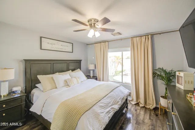 a bedroom with a large bed and a chandelier