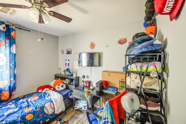 a bedroom with a bed and wooden floor