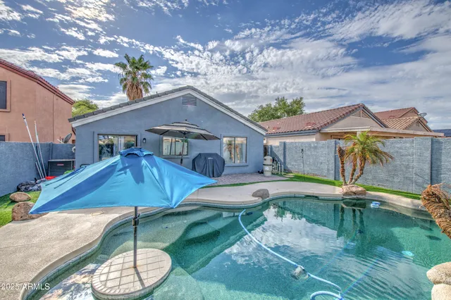 a backyard of a house with table and chairs