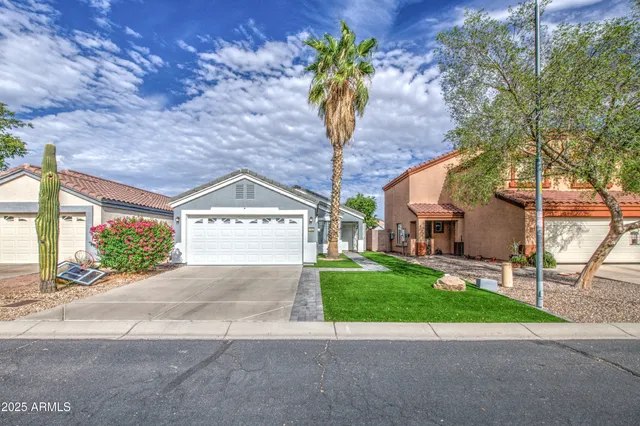 a view of a house with a yard and a garage