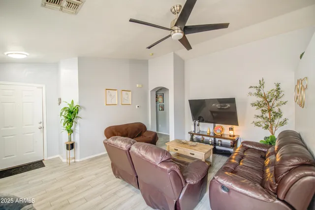 a living room with furniture and a potted plant