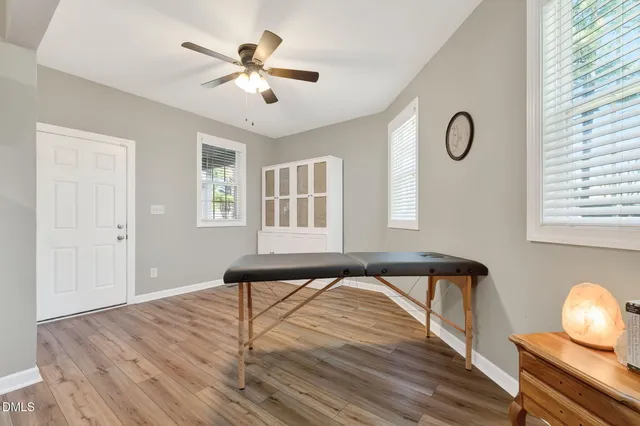 a view of room with furniture and wooden floor
