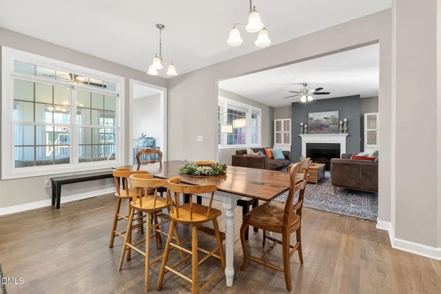 a view of a dining room with furniture wooden floor and chandelier