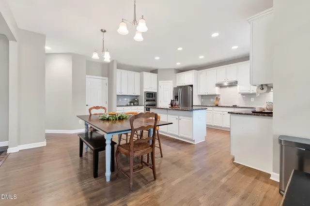 an empty room with wooden floor and balcony