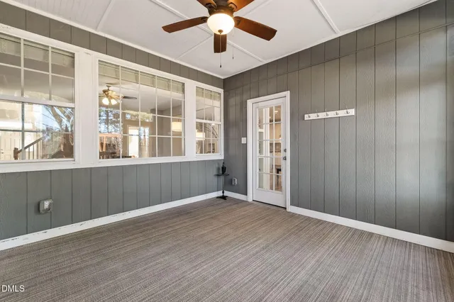 a bedroom with a bed a couch and a chandelier