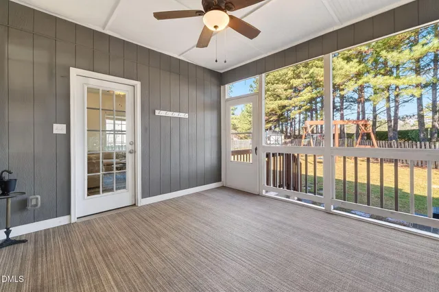 a large bathroom with a granite countertop double vanity sink a mirror and a bathtub