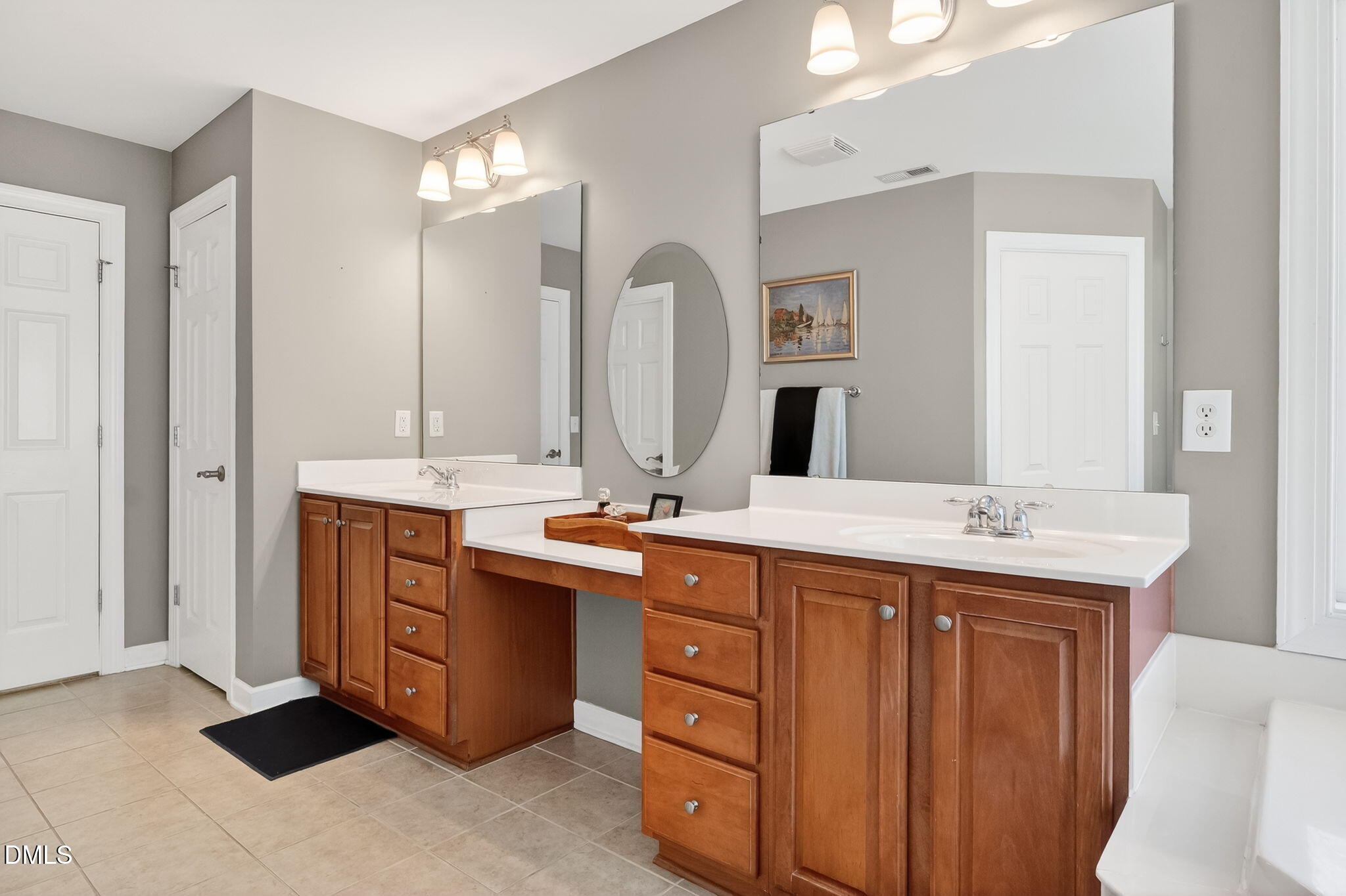 625 Toledo Court Rolesville, NC 27571 - Photo 34 of 69 a spacious bathroom with a double vanity sink and a mirror
