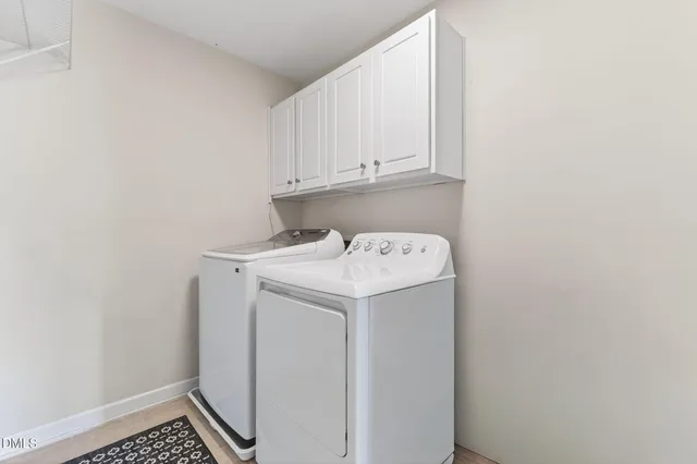 a view of swimming pool with table and chairs and wooden fence