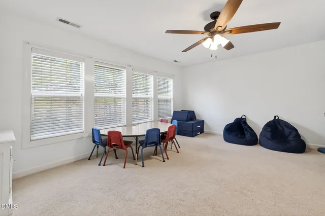 an aerial view of a house with a yard and lake view