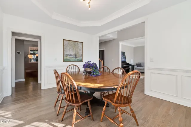 a view of a dining room with furniture and a window