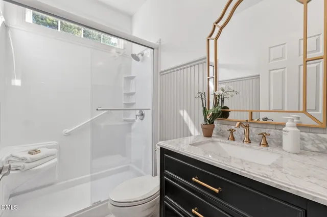 a bedroom with a bed and a table with wooden floor