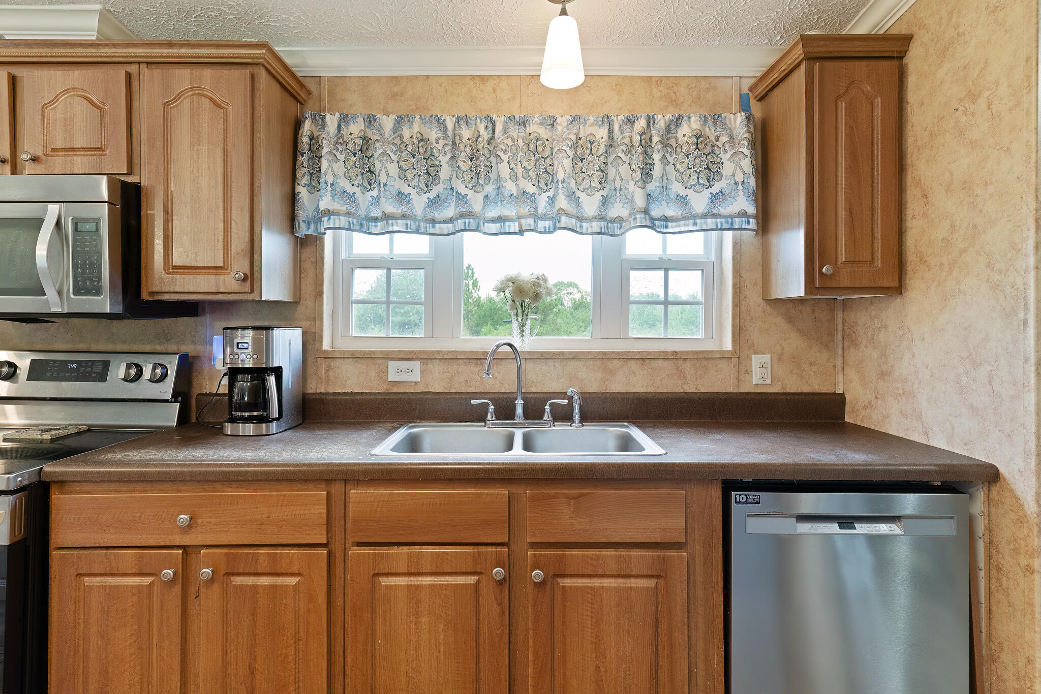 2050 Shockley Springs Road Baker, FL 32531 - Photo 13 of 49 a kitchen with stainless steel appliances granite countertop a sink a stove cabinets and a counter top space