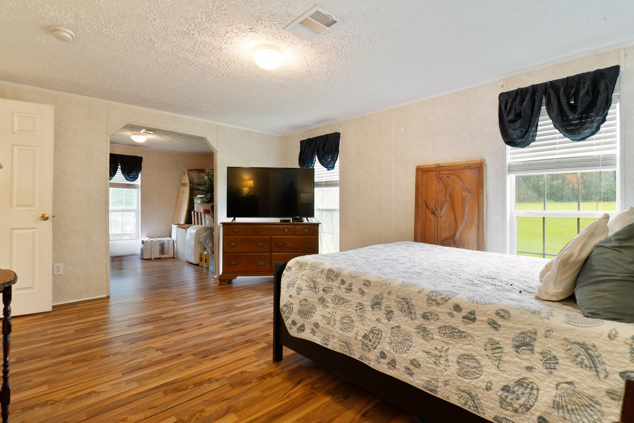 2050 Shockley Springs Road Baker, FL 32531 - Photo 15 of 49 a bedroom with a bed and a flat screen tv