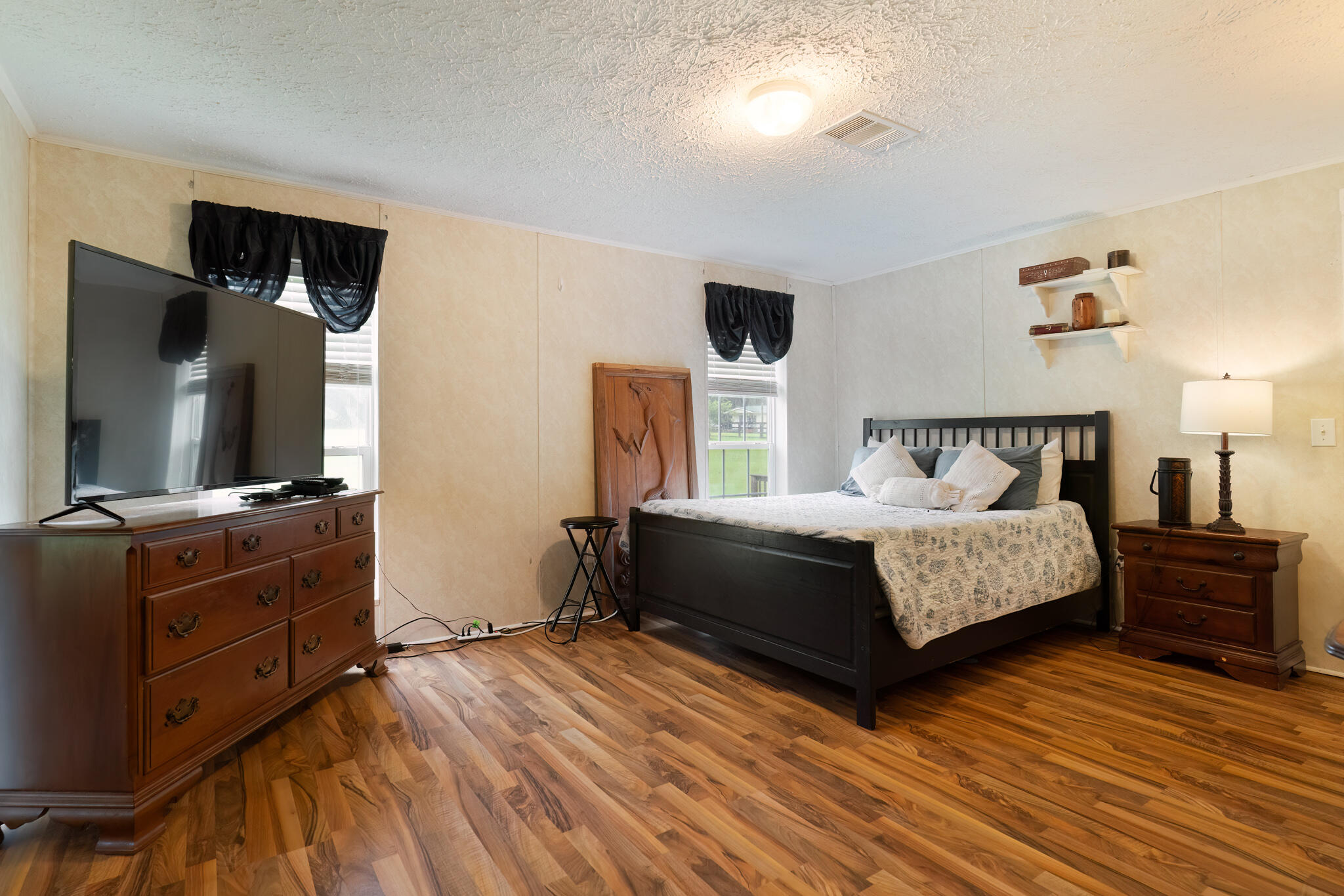2050 Shockley Springs Road Baker, FL 32531 - Photo 16 of 49 a bedroom with a bed and a flat tv screen on dresser
