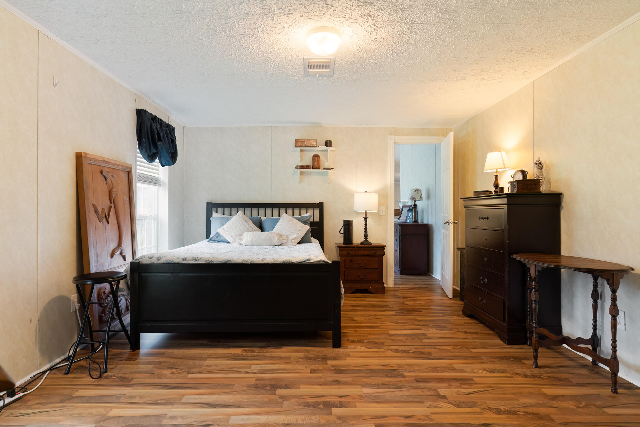 2050 Shockley Springs Road Baker, FL 32531 - Photo 17 of 49 a bedroom with a bed and wooden floor