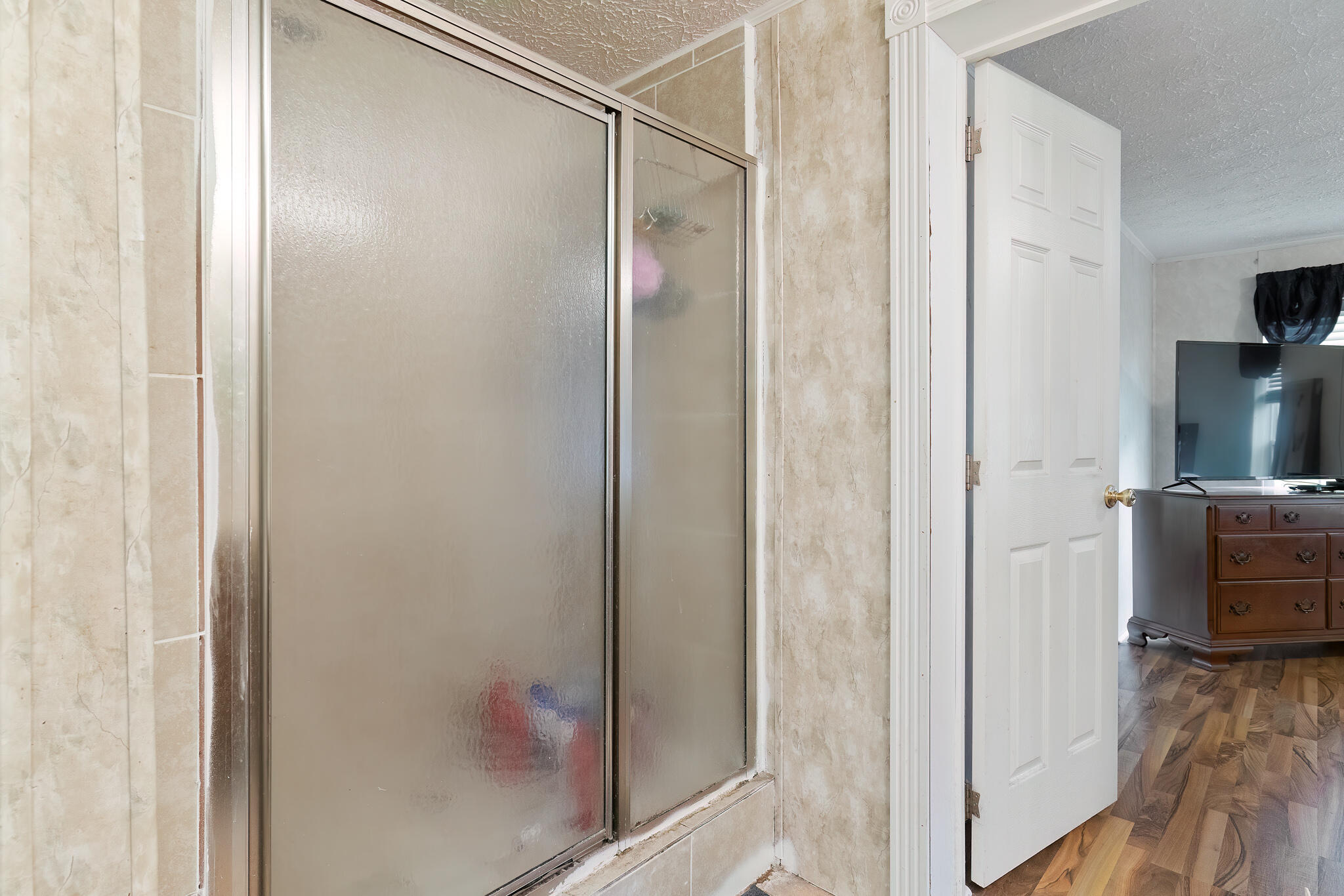 2050 Shockley Springs Road Baker, FL 32531 - Photo 20 of 49 a bathroom with a glass shower door