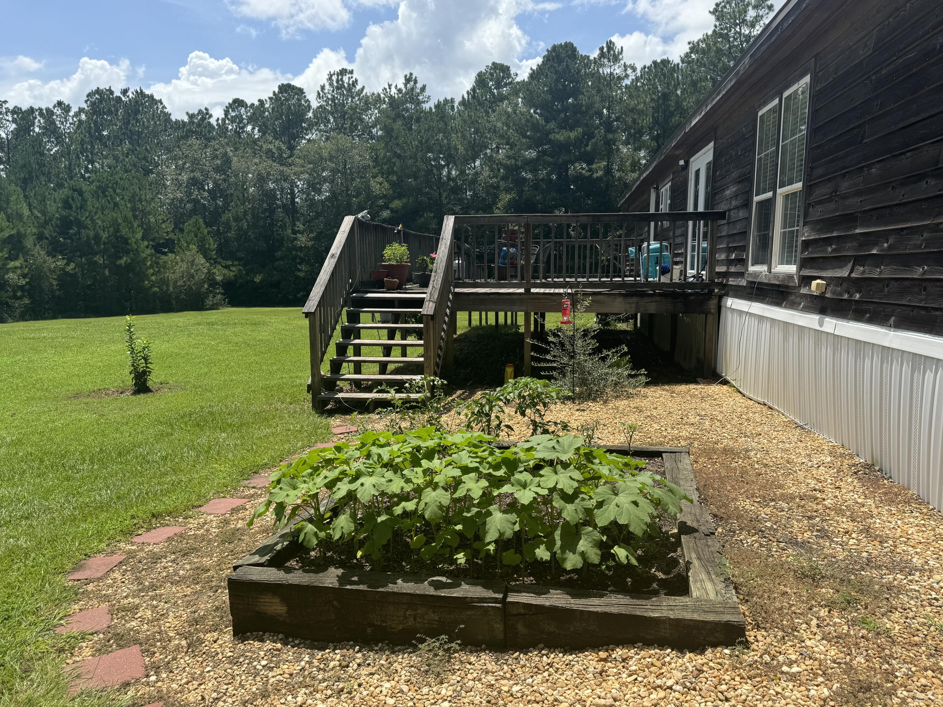 2050 Shockley Springs Road Baker, FL 32531 - Photo 23 of 49 a view of a garden with a bench