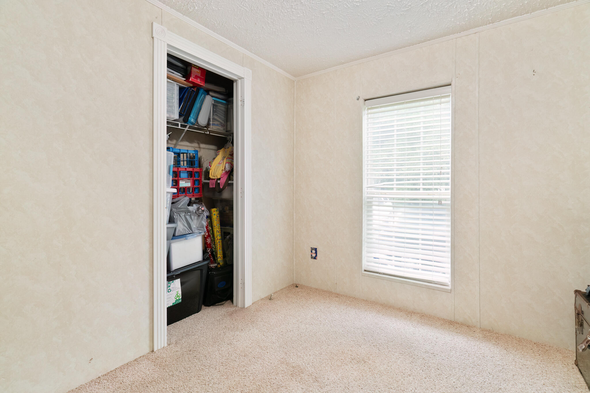 2050 Shockley Springs Road Baker, FL 32531 - Photo 25 of 49 an empty room with closet and a window