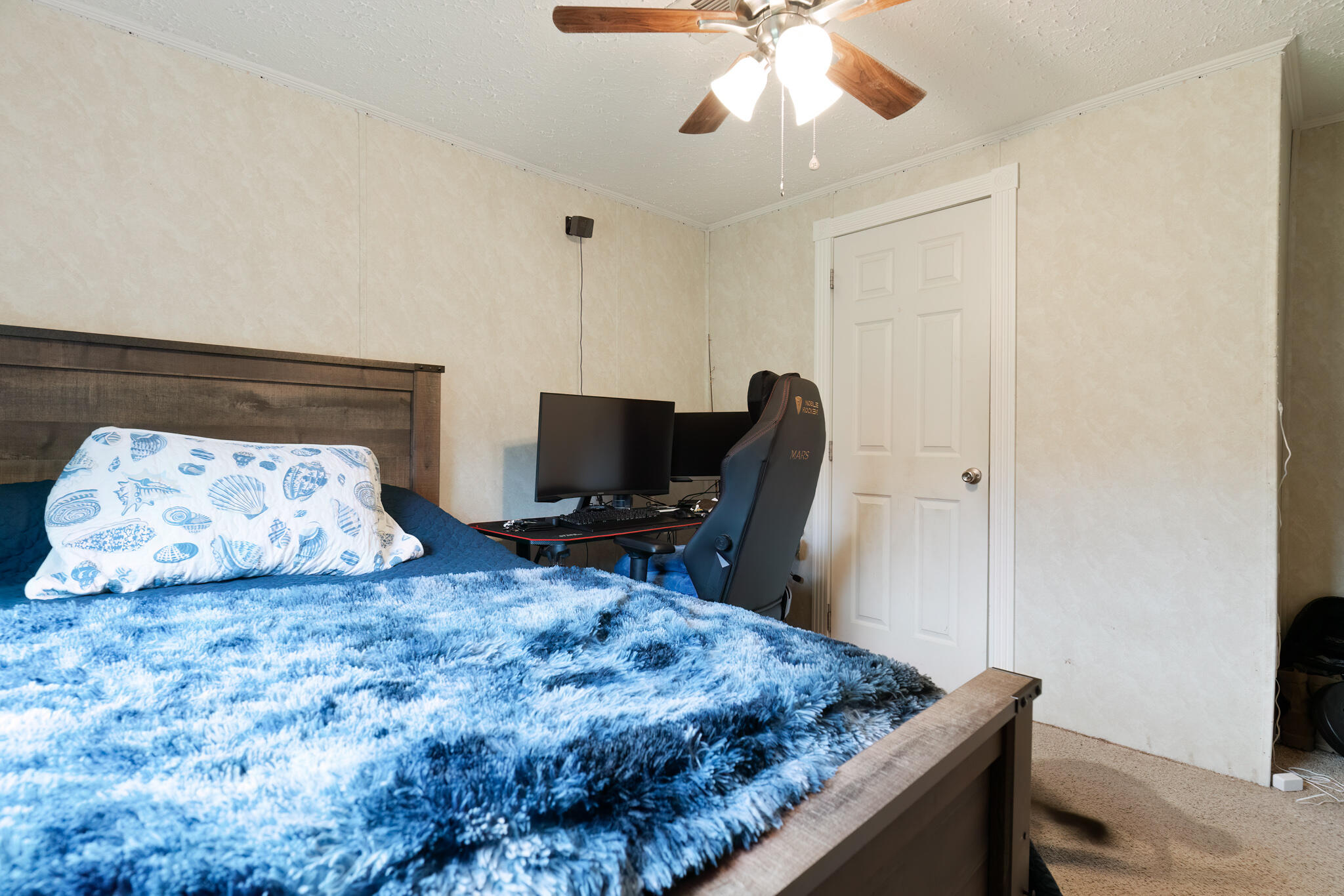 2050 Shockley Springs Road Baker, FL 32531 - Photo 27 of 49 a bedroom with bed and a flat tv screen on dresser