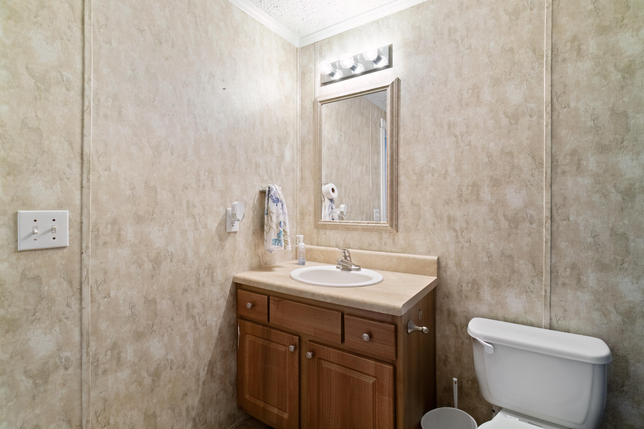2050 Shockley Springs Road Baker, FL 32531 - Photo 29 of 49 a bathroom with a toilet sink and mirror