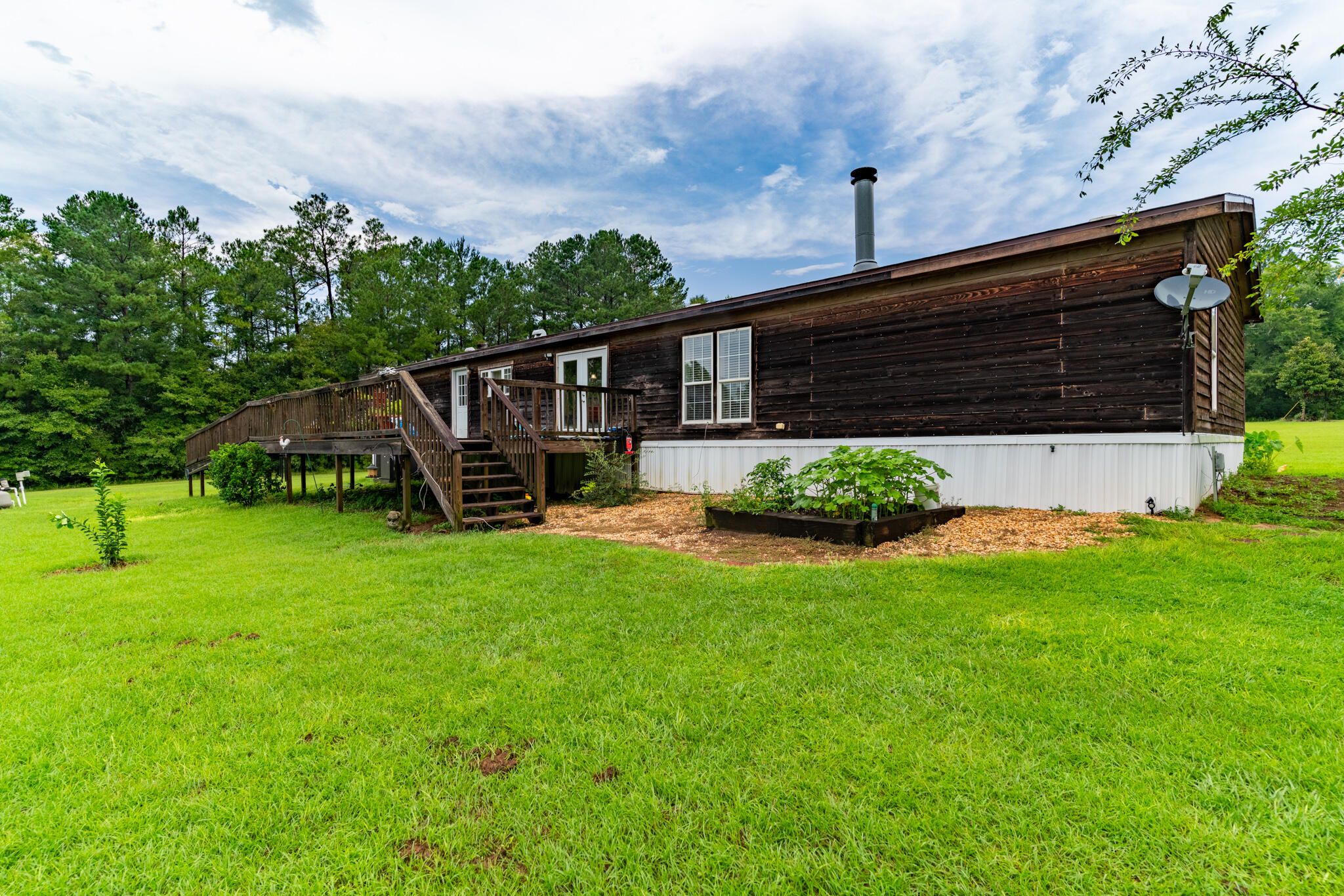 2050 Shockley Springs Road Baker, FL 32531 - Photo 34 of 49 a view of a house with backyard and garden