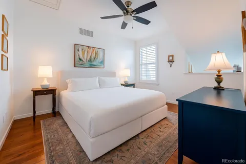 a bedroom with a bed and a lamp on desk