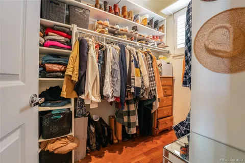 a view of walk in closet with clothes and shoes
