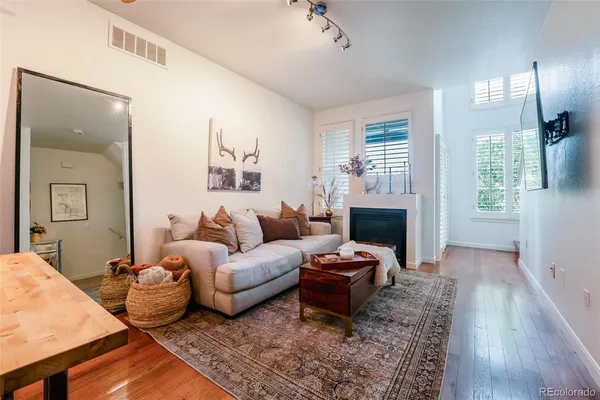 a living room with furniture wooden floor and a fireplace